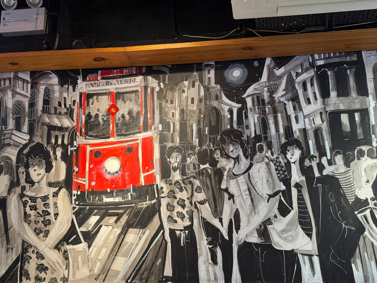 Street mural with a red tram